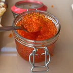 Trout roe in a glass jar, served with blinis